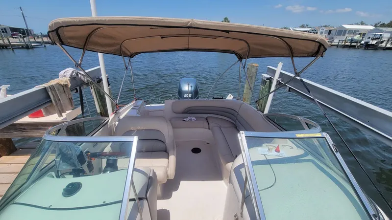 Slide: The Image of 2003 Hurricane 237 Fun Deck boat with Yamaha 200 Four Stroke engine, docked by the water. - 14