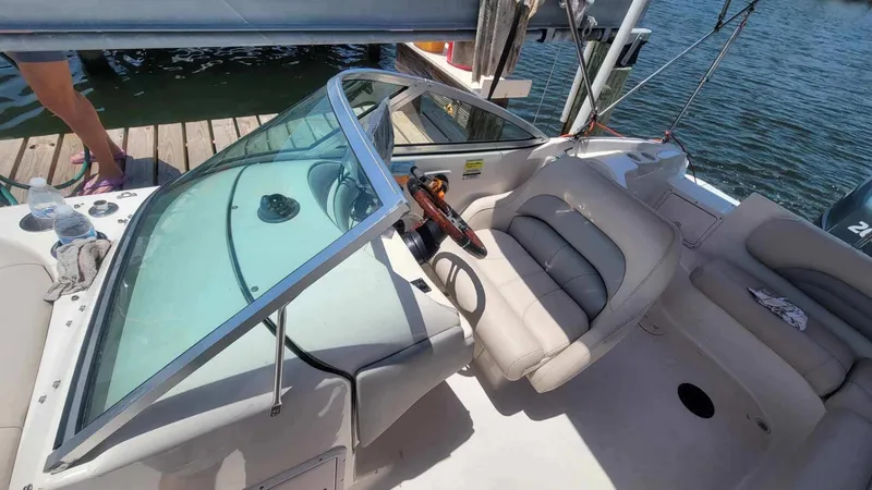 Slide: The Image of 2003 Hurricane 237 Fun Deck boat interior with Yamaha 200 Four Stroke engine, docked by water. - 15