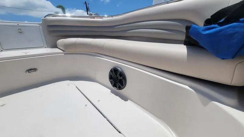 Slide: The Image of 2003 Hurricane 237 Fun Deck boat interior with beige seating and speaker. - 18