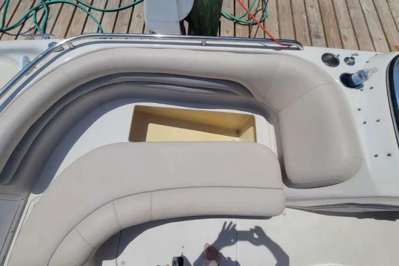 Slide: The Image of 2003 Hurricane 237 Fun Deck boat interior with beige seating and storage compartment. - 19