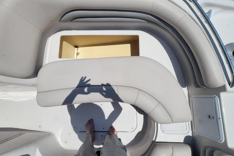 Slide: The Image of 2003 Hurricane 237 Fun Deck interior with storage compartment and seating. - 20