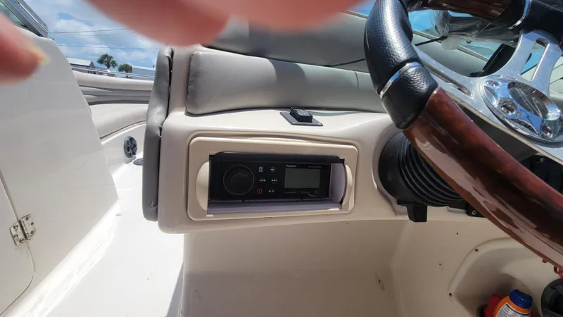 Slide: The Image of 2003 Hurricane 237 Fun Deck boat dashboard with stereo system and steering wheel. - 22