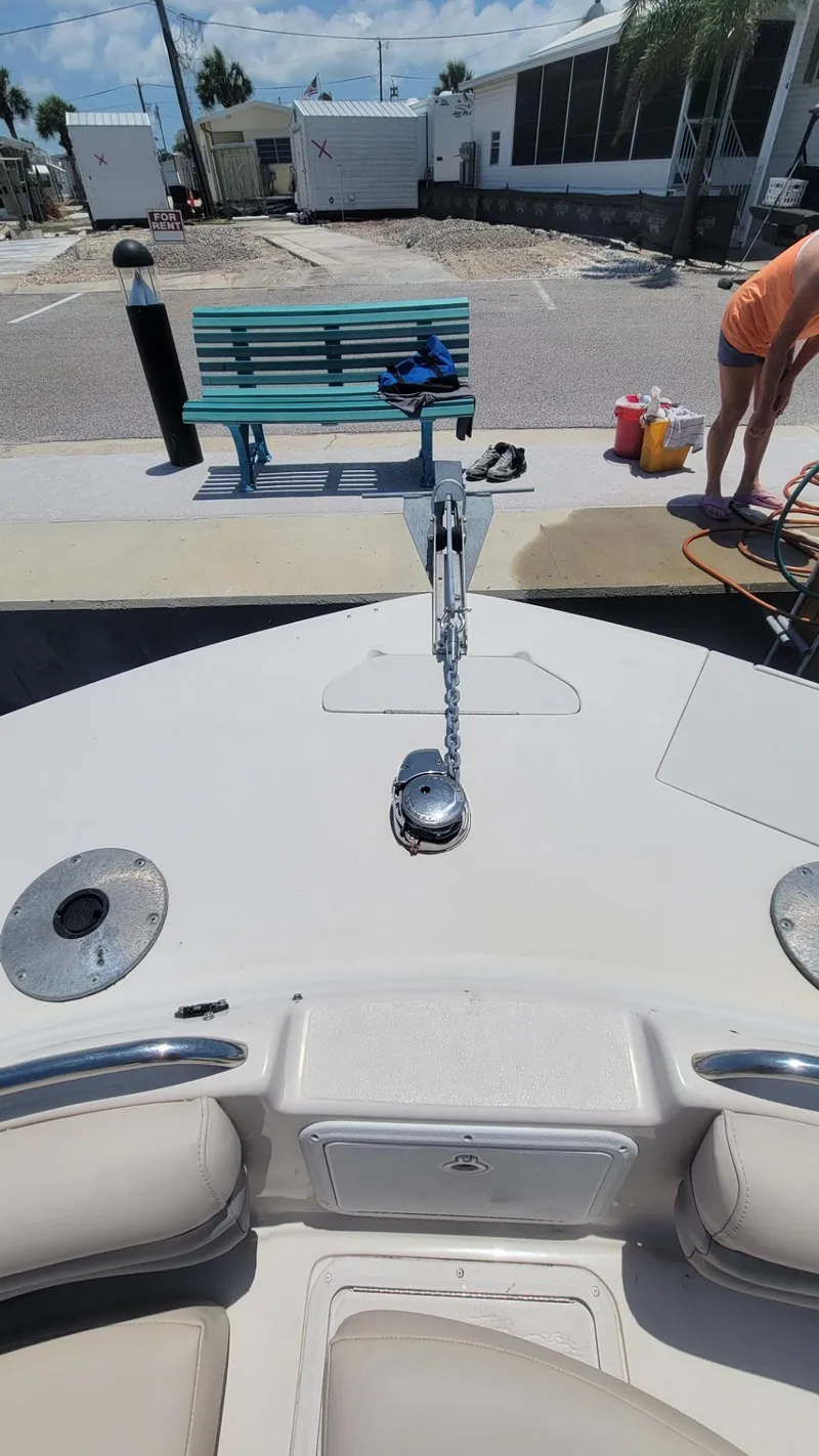 Slide: The Image of 2003 Hurricane 237 Fun Deck boat with Yamaha 200 Four Stroke engine, docked near a bench. - 25