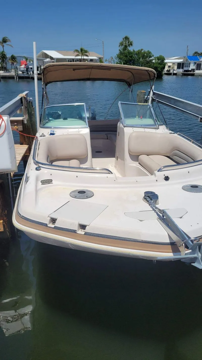 Slide: The Image of 2003 Hurricane 237 Fun Deck boat with Yamaha 200 Four Stroke, docked by waterfront homes. - 27
