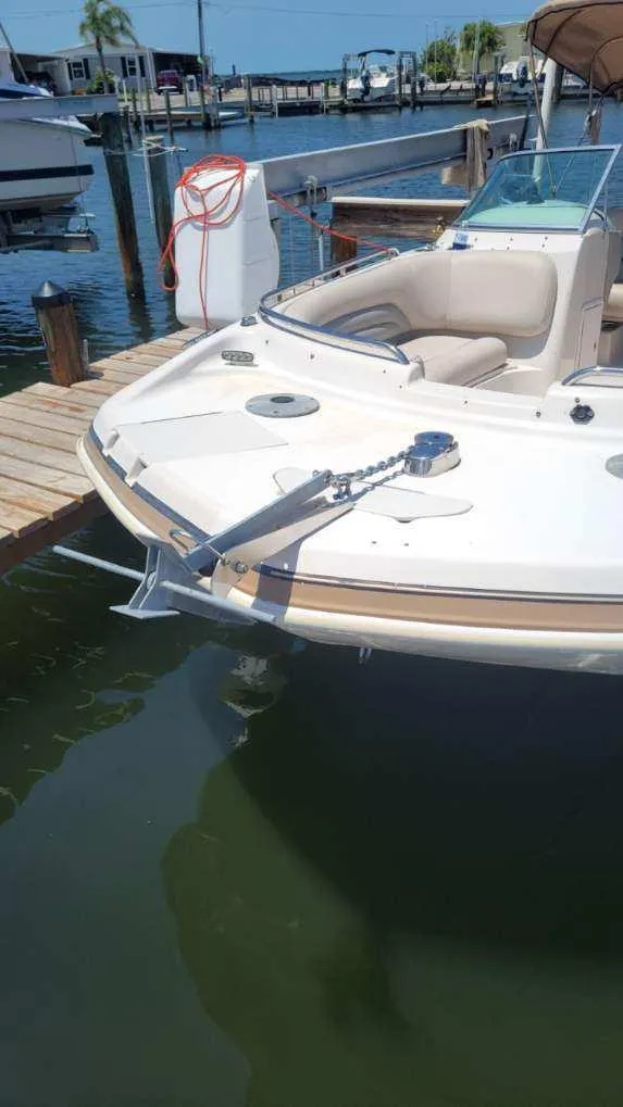 Slide: The Image of 2003 Hurricane 237 Fun Deck boat docked, featuring Yamaha 200 Four Stroke engine. - 29