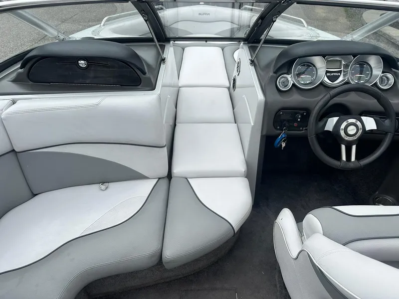 Slide: The Image of 2009 Supra Launch 22 SSV interior with sleek gray and white seating and modern dashboard. - 10
