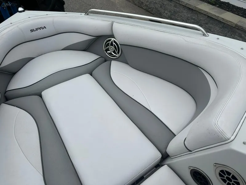 Slide: The Image of 2009 Supra Launch 22 SSV boat interior with white and gray seating. - 13