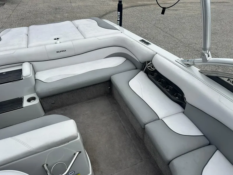 Slide: The Image of 2009 Supra Launch 22 SSV boat interior with gray and white seating. - 16