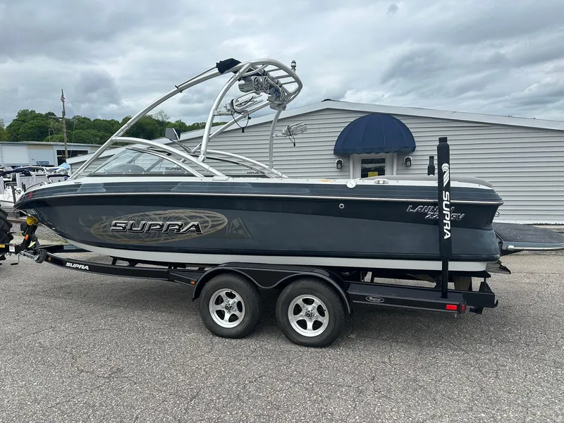 Slide: The Image of 2009 Supra Launch 22 SSV boat on trailer, parked outdoors. - 2