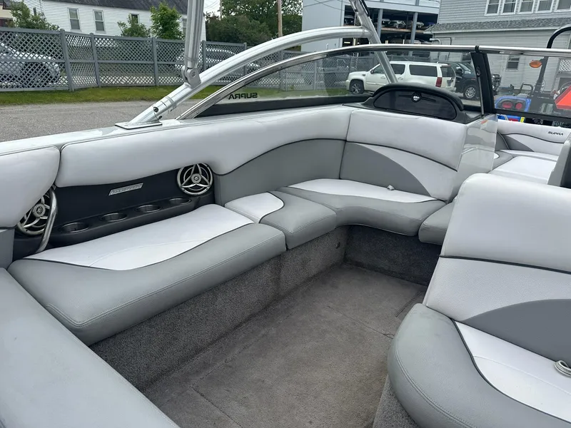 Slide: The Image of 2009 Supra Launch 22 SSV boat interior with gray seating and speaker system. - 7