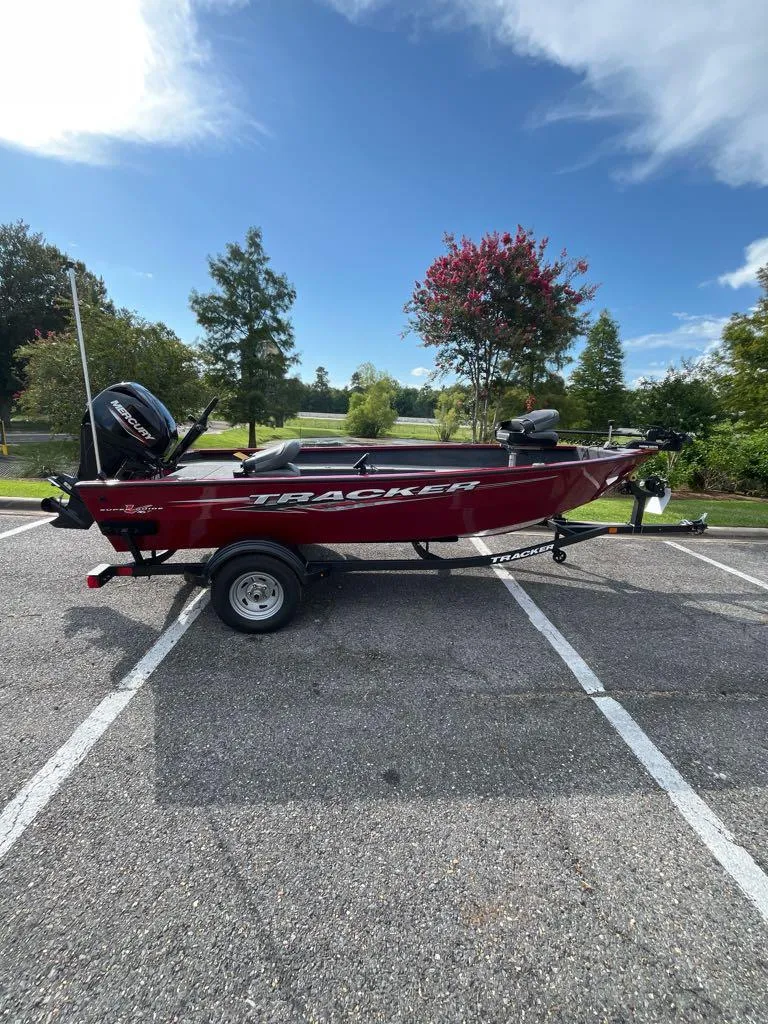 The Image of 2025 Tracker Super Guide V-16 T boat on trailer in parking lot. - 0