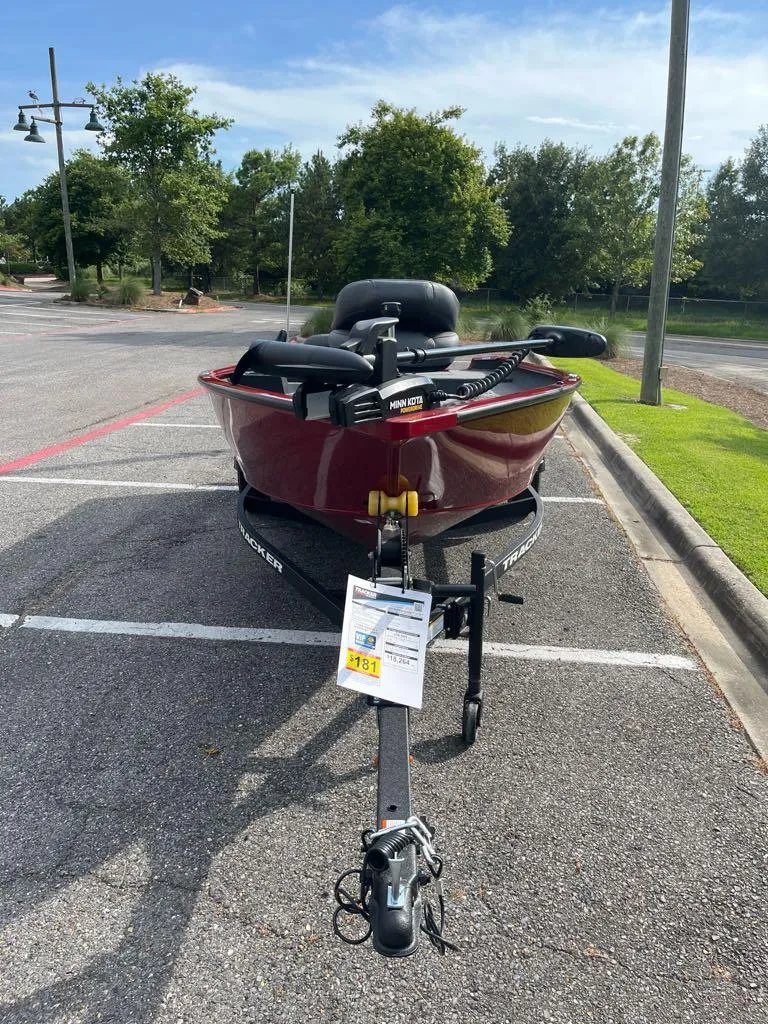 Slide: The Image of 2025 Tracker Super Guide V-16 T boat on trailer in parking lot. - 2