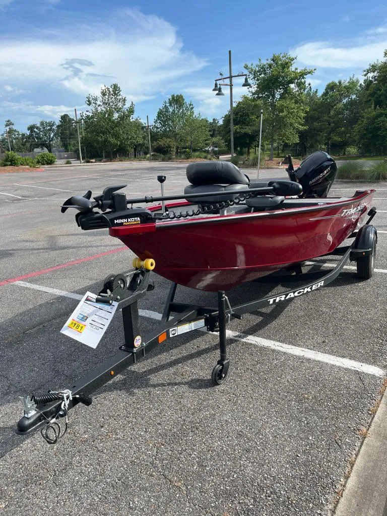 Slide: The Image of 2025 Tracker Super Guide V-16 T boat on trailer in parking lot. - 3