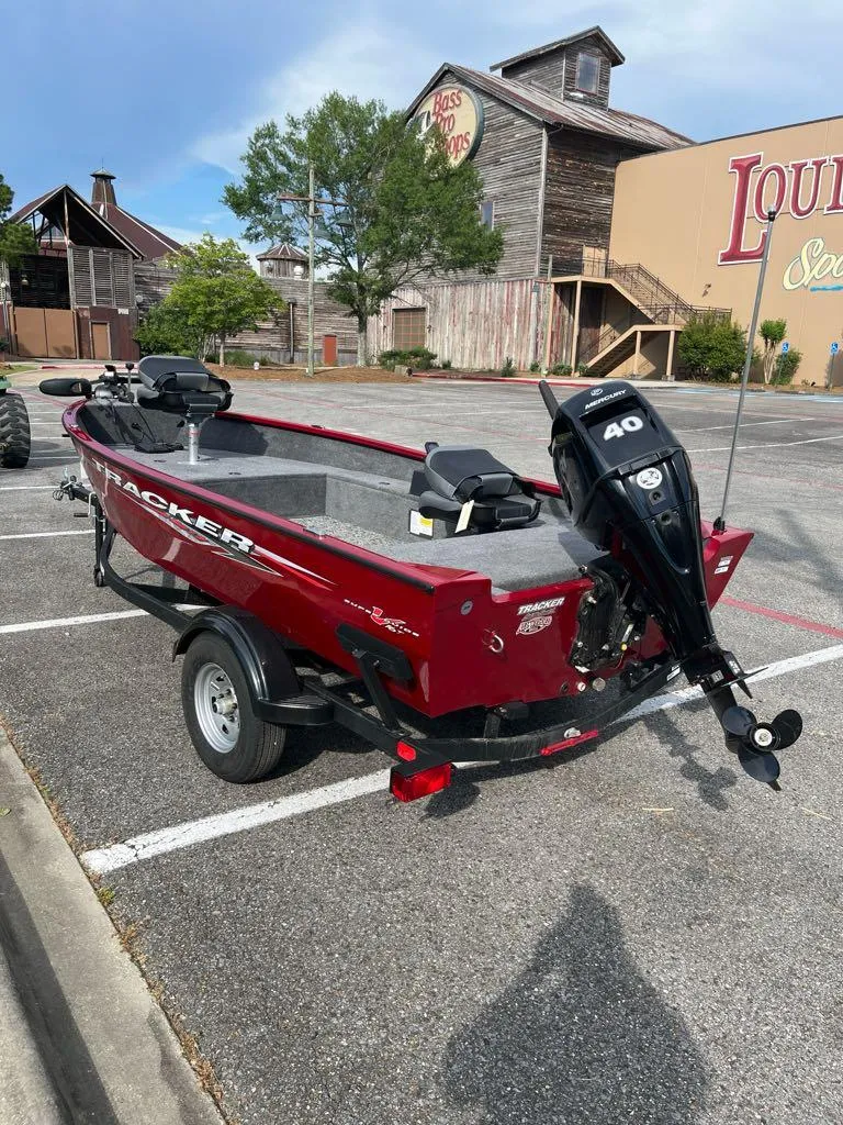 Slide: The Image of 2025 Tracker Super Guide V-16 T boat with 40 HP motor in parking lot. - 5
