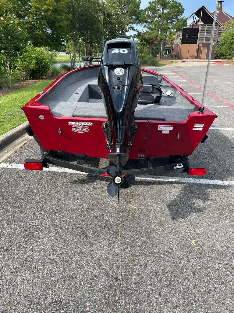 Slide: The Image of 2025 Tracker Super Guide V-16 T boat with 40 HP motor, parked outdoors. - 6