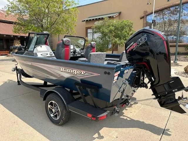 Slide: The Image of 2025 Ranger VS1782SC Reata boat with Mercury engine on trailer, parked outdoors. - 2