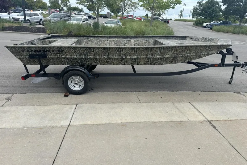 Slide: The Image of 2025 Tracker Grizzly 1860 Utility boat on trailer in parking lot. - 4