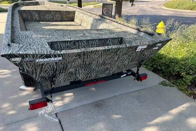 Slide: The Image of 2025 Tracker GRIZZLY 1860 Utility boat with camouflage design on a trailer. - 4