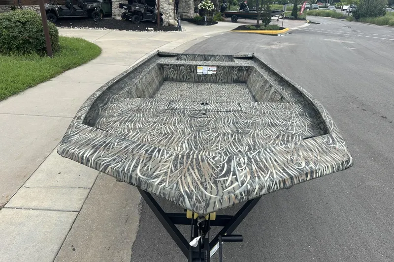 Slide: The Image of 2025 Tracker Grizzly 1860 Utility boat with camouflage pattern on a trailer. - 5