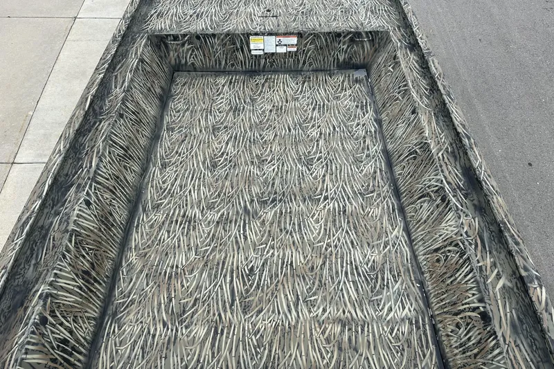 Slide: The Image of 2025 Tracker Grizzly 1860 Utility boat with camouflage interior design. - 7