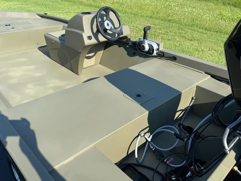 Slide: The Image of 2025 Tracker Grizzly 1648 SC boat interior with steering console and controls. - 5