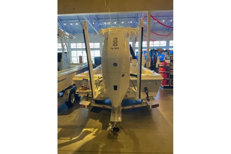 Slide: The Image of 2025 Ranger 2510 Bay boat with 400 V10 engine displayed indoors. - 2