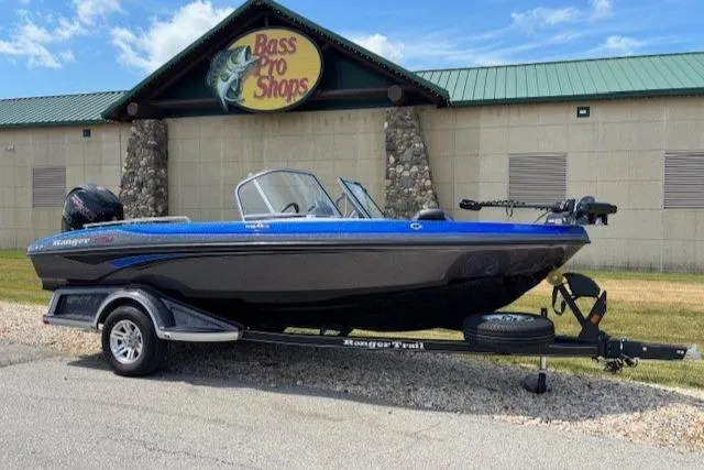 The Image of 2025 Ranger 1850MS boat on trailer, blue and black design, parked outdoors. - 0