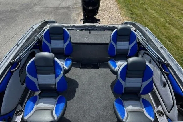 Slide: The Image of 2025 Ranger 1850MS boat interior with blue and gray seating, steering wheel, and motor. - 5