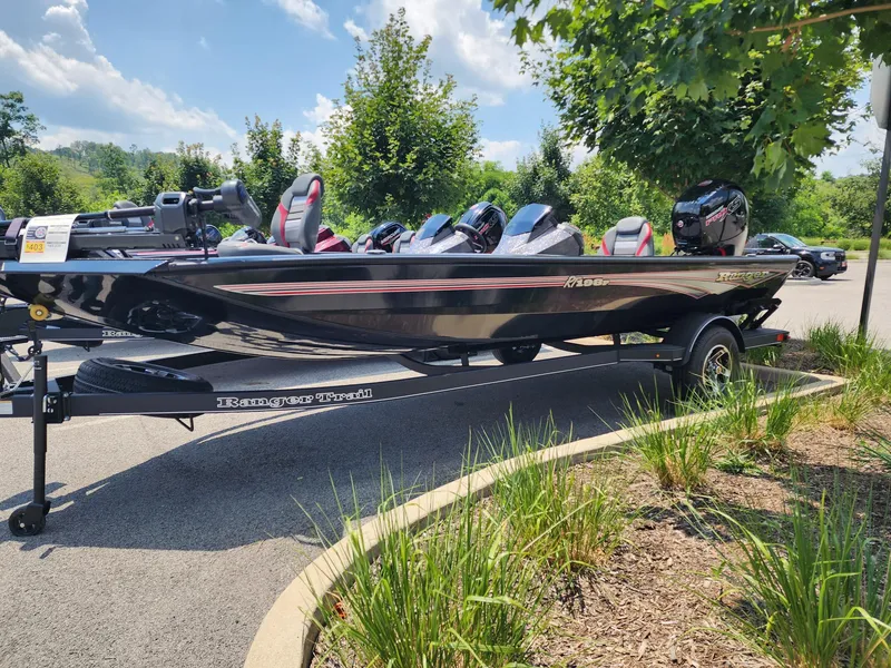 The Image of 2025 Ranger RT198P boat on trailer, parked outdoors under sunny sky. - 0