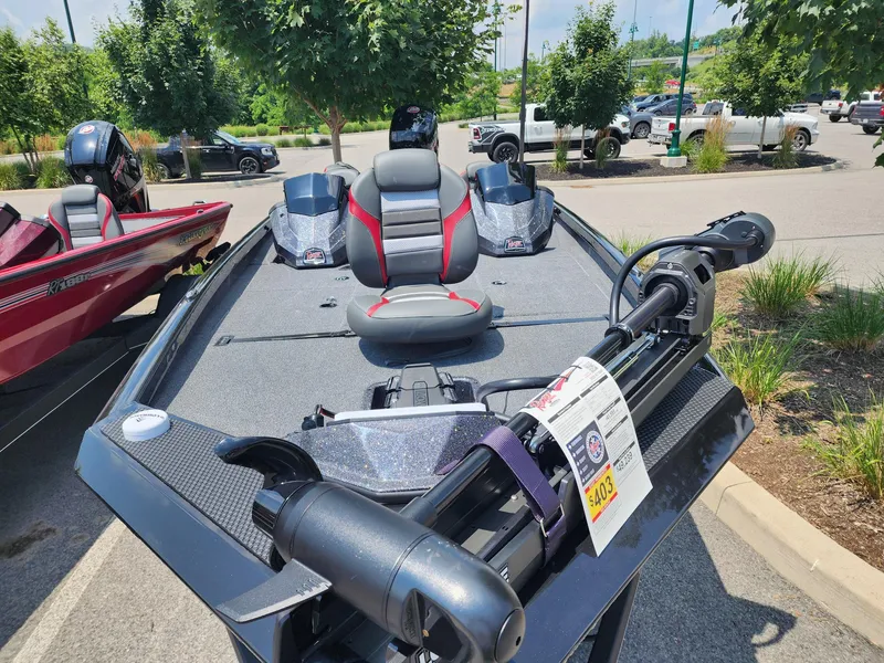 Slide: The Image of 2025 Ranger RT198P boat with seating and motor, displayed outdoors in a parking lot. - 2
