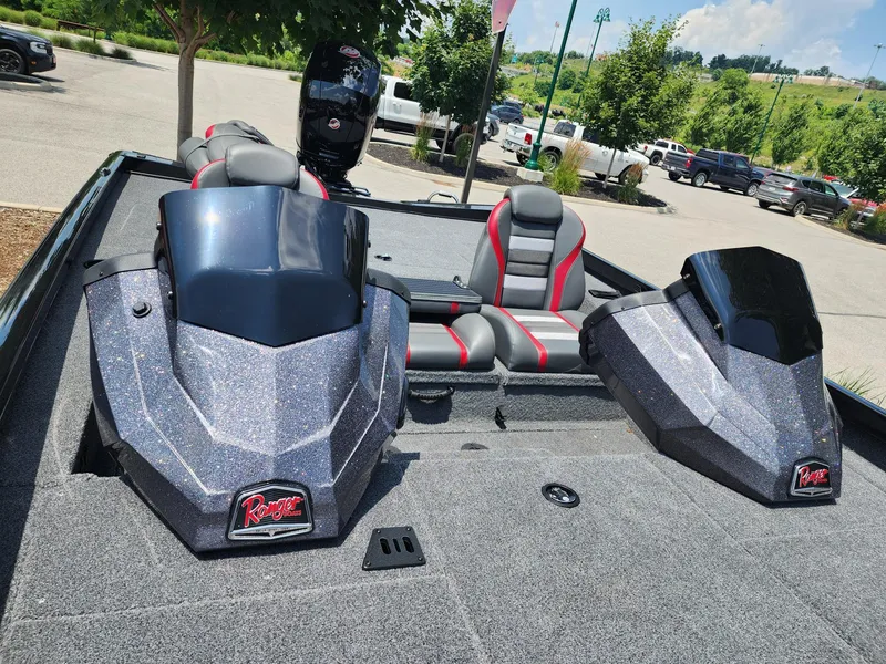 Slide: The Image of 2025 Ranger RT198P boat interior with dual consoles and seating in a parking lot. - 3