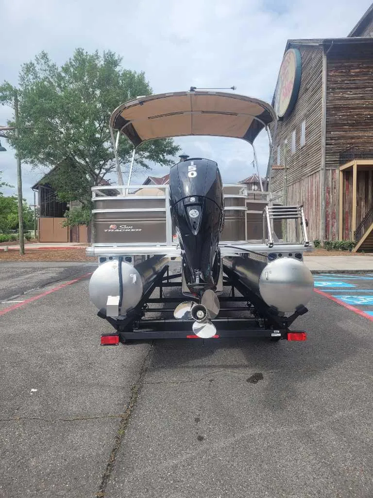 Slide: The Image of 2025 Sun Tracker SportFish 22 DLX pontoon boat parked in Louisiana. - 2