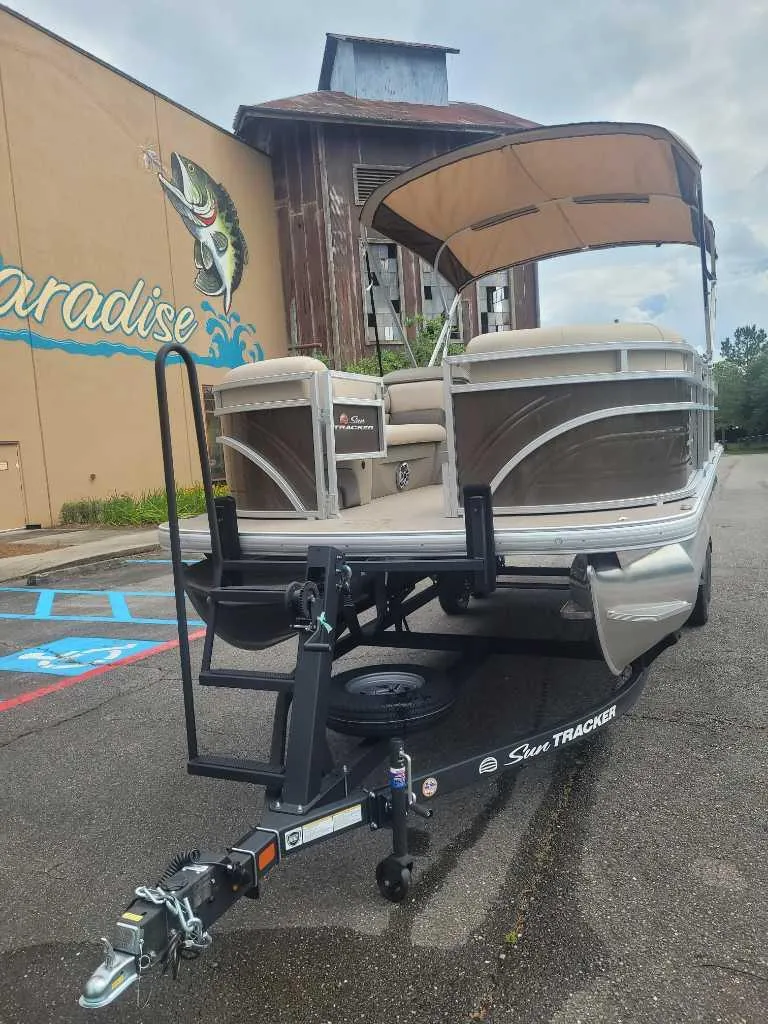 Slide: The Image of 2025 Sun Tracker SportFish 22 DLX pontoon boat with spacious seating and canopy. - 3