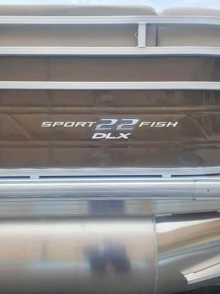 Slide: The Image of 2025 Sun Tracker SportFish 22 DLX boat seat storage compartment, open and empty. - 5