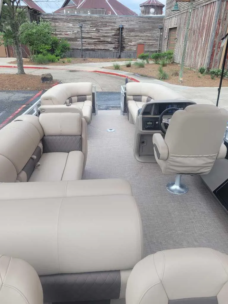 Slide: The Image of Open storage compartment on 2025 Sun Tracker SportFish 22 DLX boat with cables inside. - 9