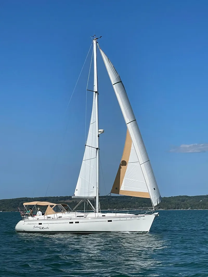 Slide: The Image of 2001 Beneteau 411 sailboat on open water under clear blue sky. - 14