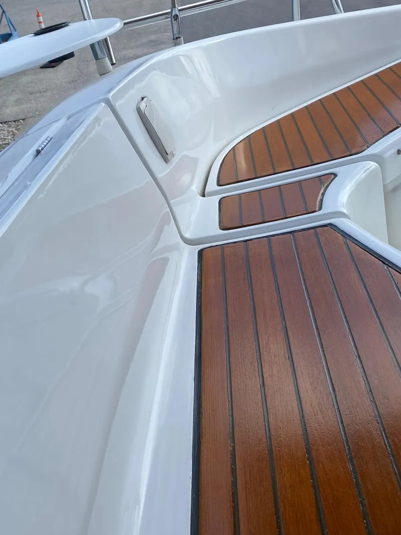 Slide: The Image of 2001 Beneteau 411 sailboat with sleek white deck and polished wood accents. - 5
