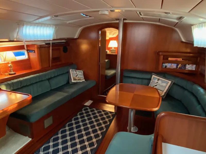 Slide: The Image of Interior of 2001 Beneteau 411 yacht with wooden furnishings and teal seating. - 6
