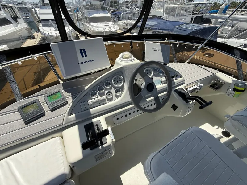 Slide: The Image of 1996 Silverton 362 Sedan Cruiser helm with navigation equipment and steering wheel. - 17