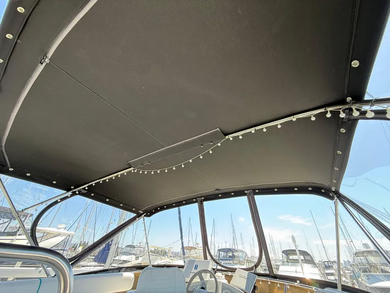 Slide: The Image of Interior view of 1996 Silverton 362 Sedan Cruiser with canopy and marina background. - 21