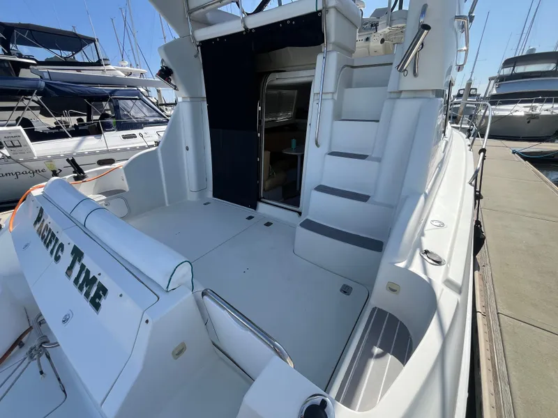 Slide: The Image of 1996 Silverton 362 Sedan Cruiser docked, showing spacious deck and entryway. - 9