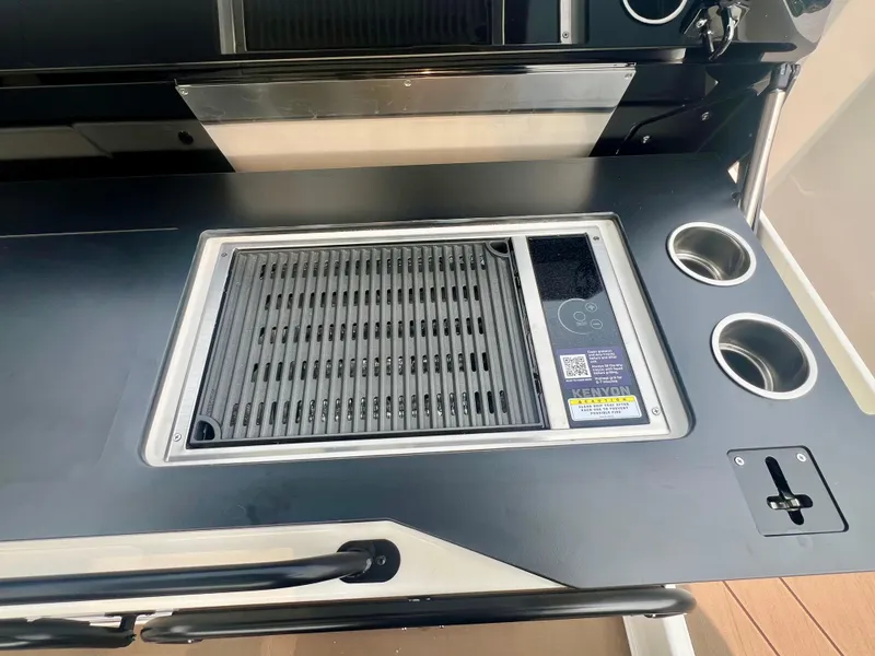 Slide: The Image of Outdoor grill setup with integrated stovetop, Navan S-30, 2025 model, featuring dual cup holders. - 21