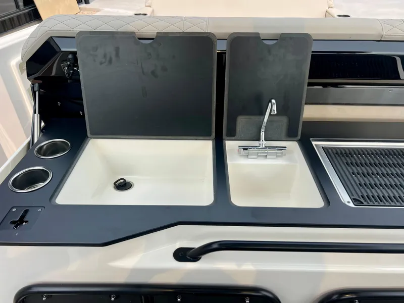 Slide: The Image of Navan S-30 2025 boat kitchen with sink, faucet, and grill area. - 22