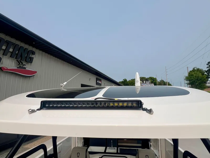 Slide: The Image of Navan S-30 2025 boat roof with LED light bar, near a boating facility. - 28