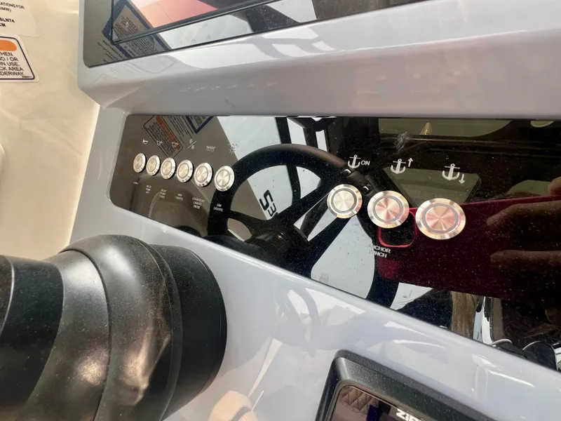 Slide: The Image of Control panel of 2025 Navan S-30 boat with steering wheel and buttons. - 32