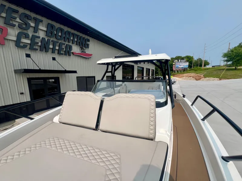 Slide: The Image of 2025 Navan S-30 boat at dealership, featuring sleek design and comfortable seating. - 38