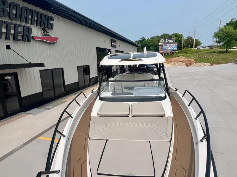 Slide: The Image of 2025 Navan S-30 boat at dealership, showcasing sleek design and spacious deck. - 39