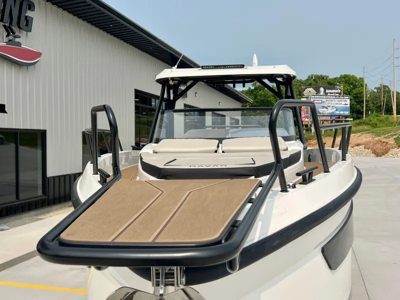 Slide: The Image of 2025 Navan S-30 boat with sleek design, docked near a modern building. - 6