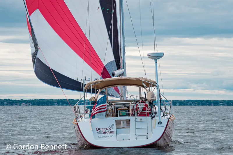 Slide: The Image of Sailing yacht Beneteau Oceanis 43, 2008 model, on open water with colorful sails. - 1