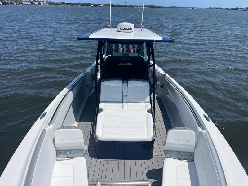 Slide: The Image of 2024 Nor-Tech 390 Sport Center Console boat on open water, featuring spacious seating and sleek design. - 13